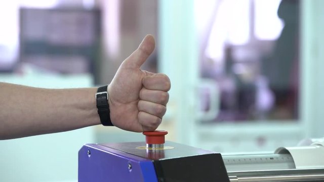 The employee presses the button and shows a thumb up