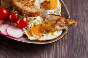 Healthy simple breakfast with bread toast, fried eggs and vegetables