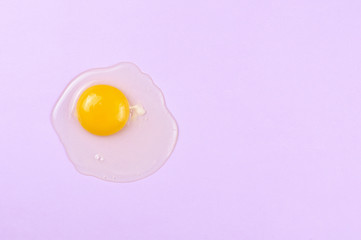 Raw egg whip on a lavender background. Flat lay, copy space