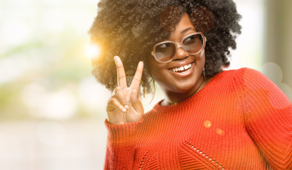 Beautiful african woman happy and excited expressing winning gesture. Successful and celebrating...
