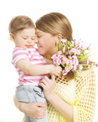Obraz na płótnie Canvas Mother and Baby Gives Flower Bouquet Gift, Mom Embrace her Daughter, Happy Family with Child Girl one year old