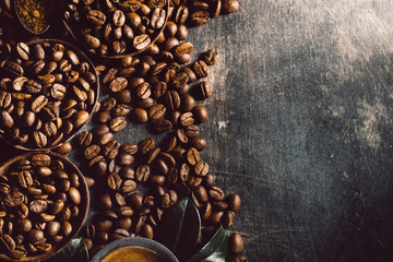 Cup of brewed coffee among aromatic beans