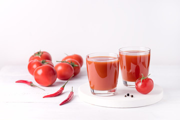 Glasses of Tasty Tomato Juice with Raw Tomatoes on White Wooden Background Healthy Diet Detox Drink