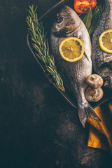 Fish with spices and vegetables in pan