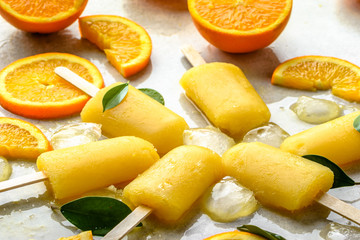 Orange popsicle with fresh oranges and ice, summer refreshing concept