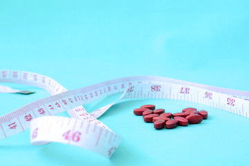 Weight loss for a limited time by taking medicine, Weight loss pills with clock and measuring tape