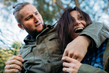 Fototapeta premium Walk a guy and a girl. Love story by the lake in the tall grass. Youth in nature.