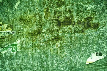 Torn poster after vote on tin textured wall. Ripped newspaper