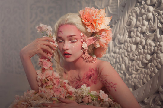 lovely she-elf among flowers. Creative make-up and bodyart