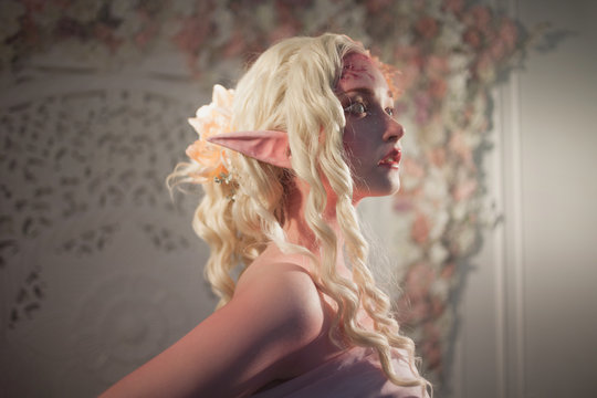 Attractive elf portrait on light background. Fantasy and fairy tale, computer games.