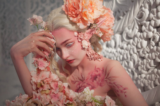 lovely she-elf among flowers. Creative make-up and bodyart
