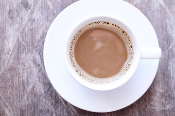 Top view of hot coffee in white cup on old wooden table, Time to Wake up, vintage color tone