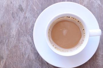Top view of hot coffee in white cup on old wooden table, Time to Wake up, vintage color tone