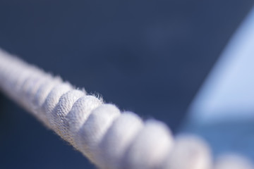 Mooring line close-up with blur in the background of the ship at the sea terminal