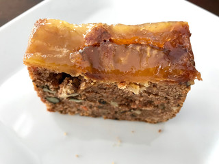 Pineapple and Carrot Cake Slice served with fork at cafe shop