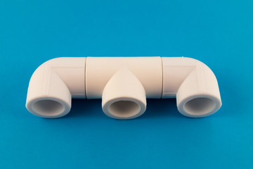 Fittings for the installation of water pipes - tee and two corners of white plastic for soldering...