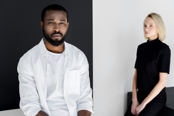 african american boyfriend and blonde girlfriend in black and white room