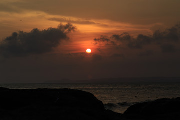 fishing boat to the sea at sunset