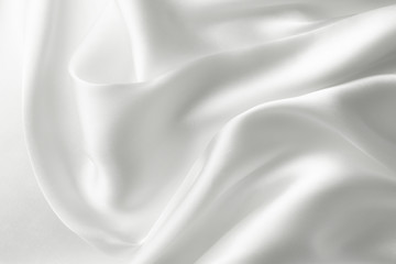 Elegant white satin silk with waves, abstract background