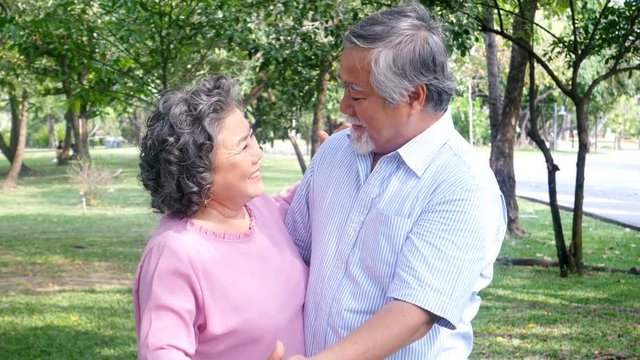 Senior asian couple dance at park together. People lifestyle concept. 4k Resolution. 