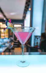 Pink cocktail Martini on counter bar