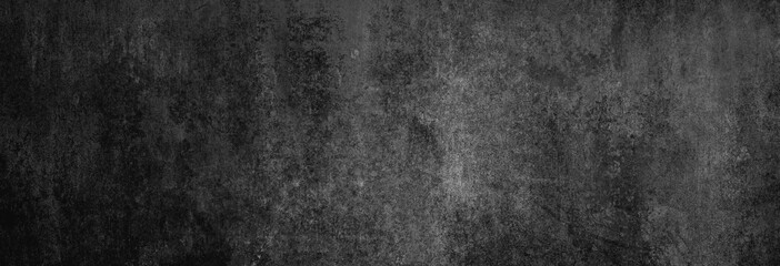 Beton-Textur in fast schwarz in XXL-Größe als Hintergrund, auf die Betonwand fällt leichtes Licht