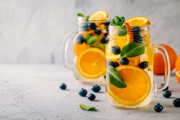  Infused detox water with orange, blueberry and mint. Ice cold summer cocktail or lemonade. © nblxer