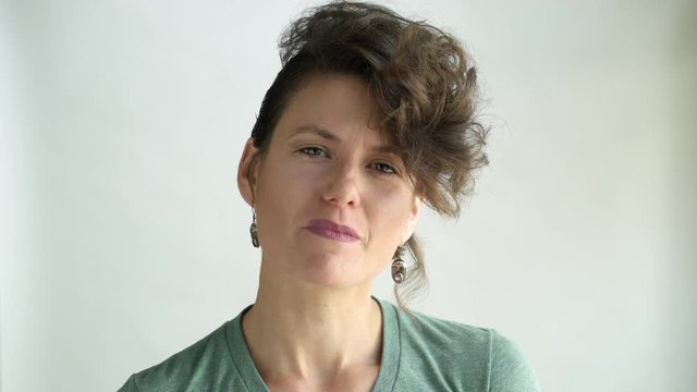 Uncertain mid adult woman, studio shot.