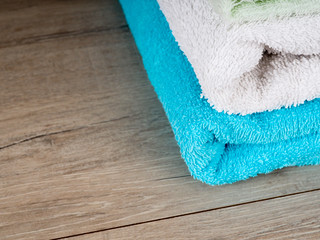 Obraz na płótnie Canvas Stack of colorful bath towels. Pastel colors cotton towels. Hygiene, fabric, spa and textile concept
