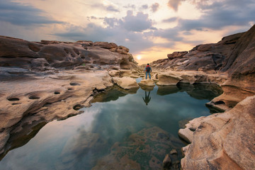 Fototapeta na wymiar Man hiking at morning mountains with heavy backpack Travel Lifestyle wanderlust adventure concept summer vacations outdoor alone Thailand grand canyon (sam phan bok) at Ubon Ratchathan