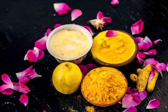 Chana,haldi,limbo & milk  ka ubtan or ayurvedic face pack of Turmeric, Lemon,gram flour & milk on wooden surface for good skin and no black heads or any skin related problems.