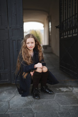 Fototapeta na wymiar portrait of young girl in black coat