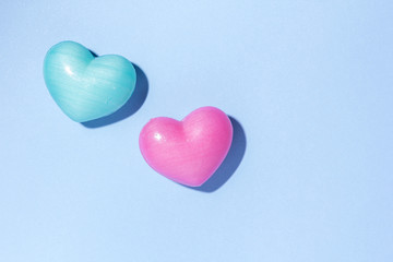 Obraz premium Couple of heart shape over blue table. Romantic Valentine Day concept with copy space