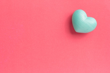 Blue heart shape over red table. Romantic Valentine Day concept with copy space