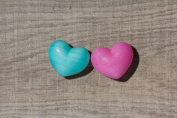 Couple of blue and red heart shapes over wooden table. Valentine day. Background use. Concept of love and romance.
