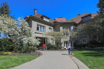 Pittock Mansion, view on the house surrounded by trees from the garden on a beautiful sunny spring day, Portland
