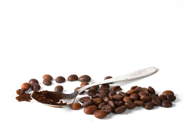 Grain of coffee, beans and a coffee spoon on a white background. Close-up