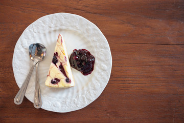 blueberry cheesecake on white plate on wood table