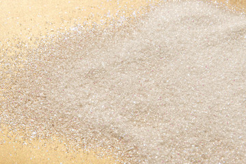 Classic shiny pastel gold and white glitter background with selective focus - glitter powder - abstract