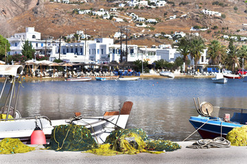 Restaurants, tavernas and fishing boats at Livadi Village in Serifos Island, Greece - obrazy, fototapety, plakaty