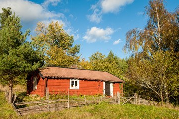 Old cottage in the countryside of Vikbolandet during autumn in Sweden