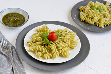 Cooked fusilli pasta on a plate with pesto, Italy food, healthy concept, vegetarian
