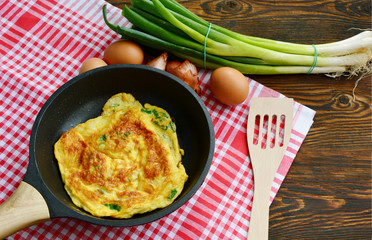Scallion or Spring onions omelet Thai style  in wok (Thai name is Kai Jieow Tonhorm).
Famous and easy Thai food menu for all ages.
Eggs Thai menu