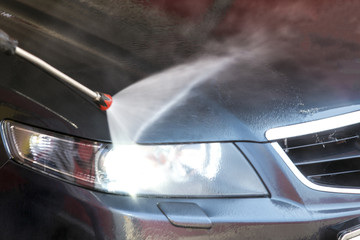 Obraz premium washing machine clean water jet aimed at the included headlight, close-up photo
