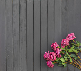 red roses on a black wooden background