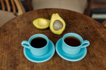 blue cup of coffe and avocado