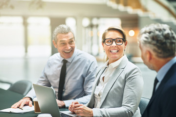 Smiling mature businesspeople working together in a modern offic