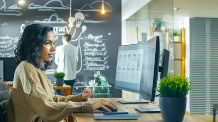 Beautiful Woman Mobile Game Application Developer Works on a Personal Computer, Designing...