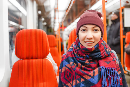 beautiful young woman sitting in metro train