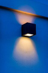 glowing modern wall lamp in the evening